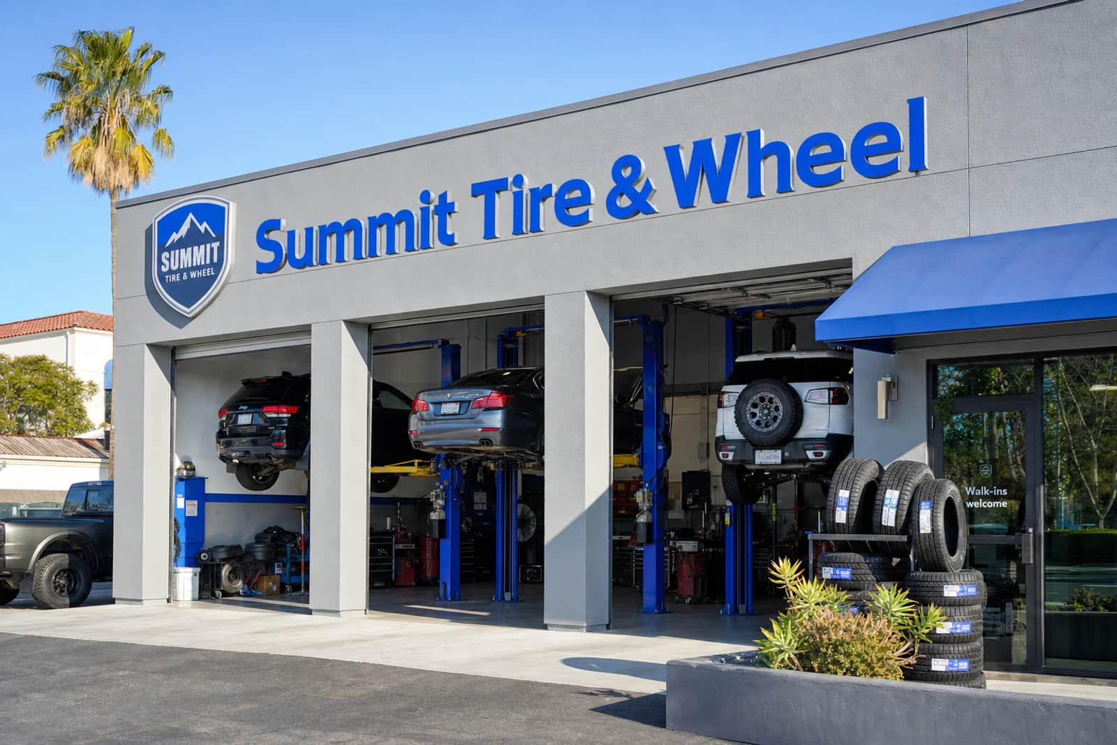 Summit Tire & Wheel, a tire shop with blue signs and open service bays
